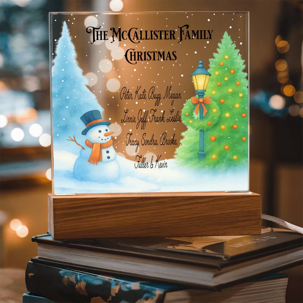 Personalized Christmas family name plaque with snowman and Christmas tree design on a wooden base.