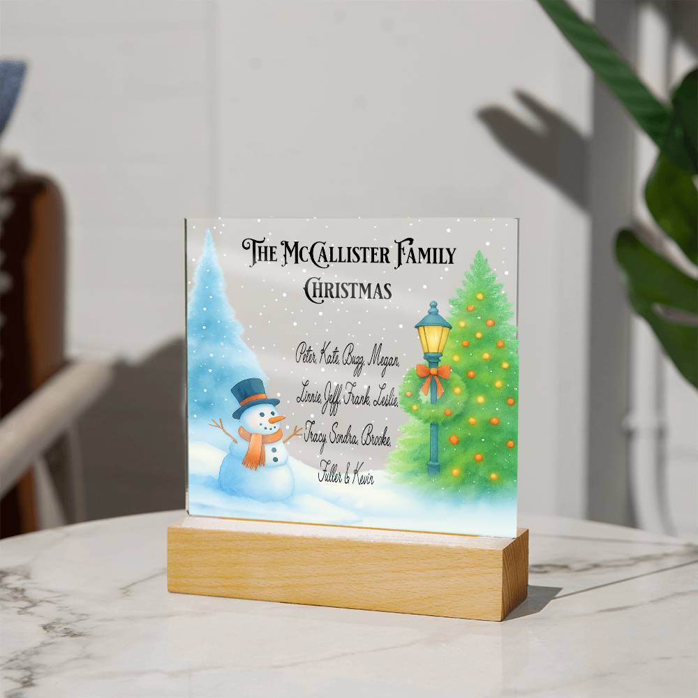 Personalized Christmas display with family names and festive elements on a stand.