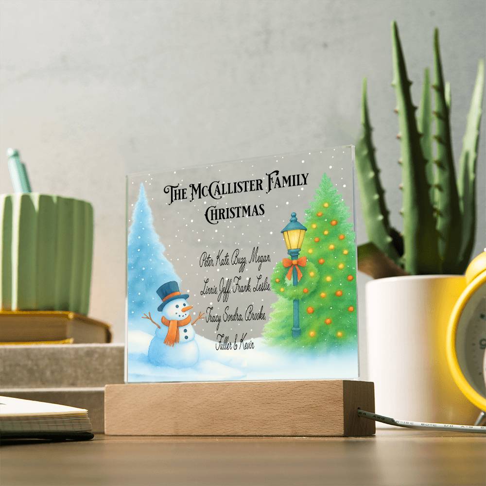 Personalized Christmas led sign with a snowman and tree design on a wooden stand, surrounded by decorative items.