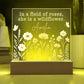 Decorative lamp with floral design and text 'In a field of roses, she is a wildflower. 
