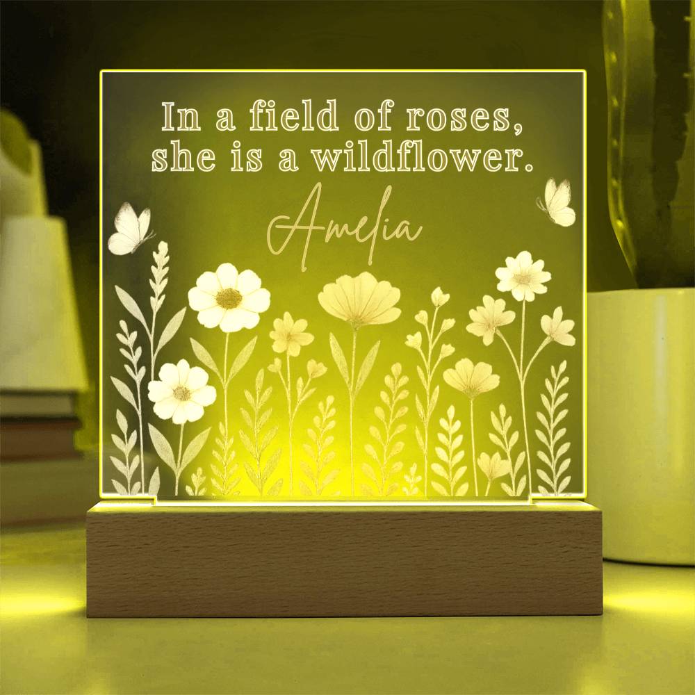 Decorative lamp with floral design and text 'In a field of roses, she is a wildflower. 