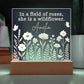 Decorative sign with floral design and text on a dark background