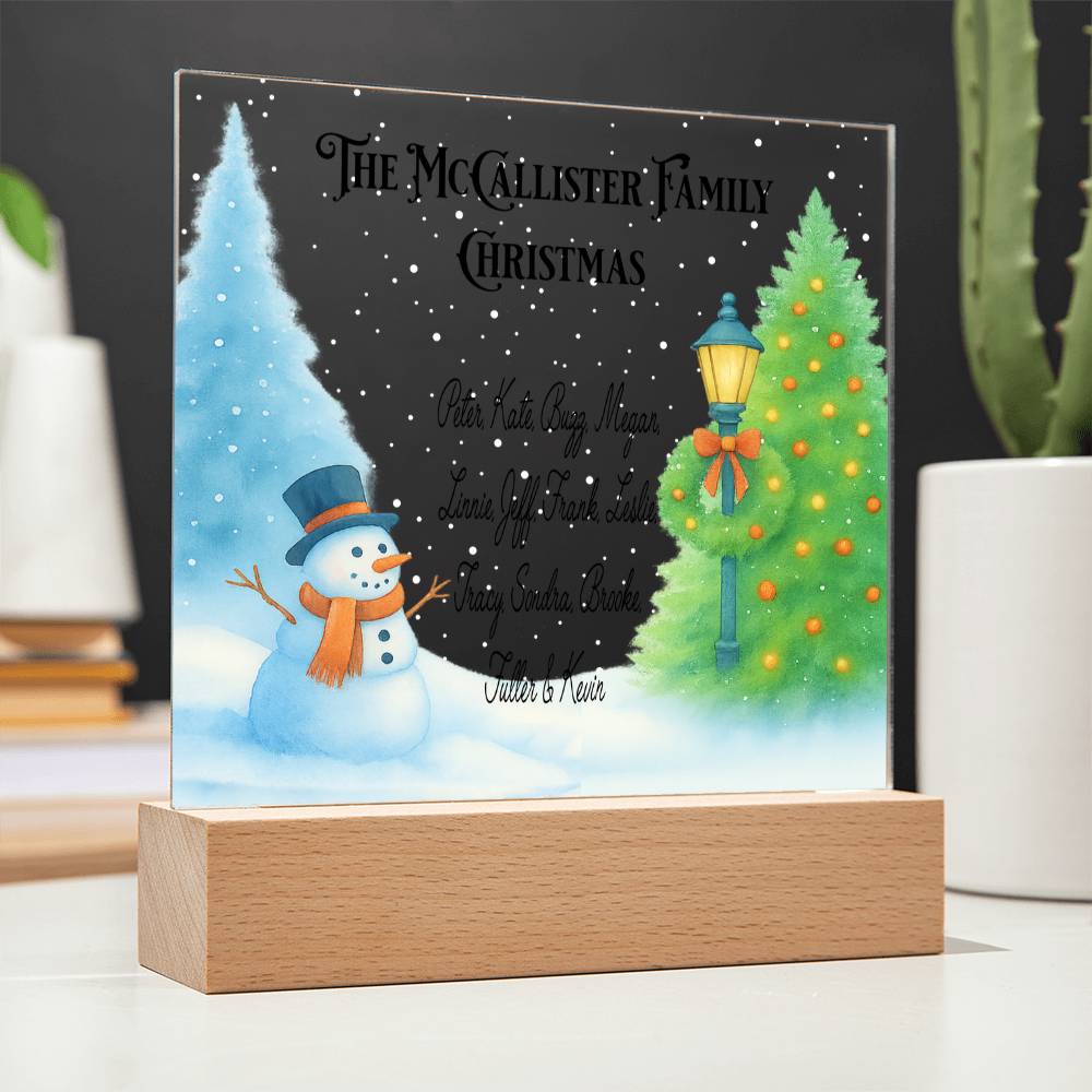 Personalized Christmas decoration with snowman and tree design on a stand.