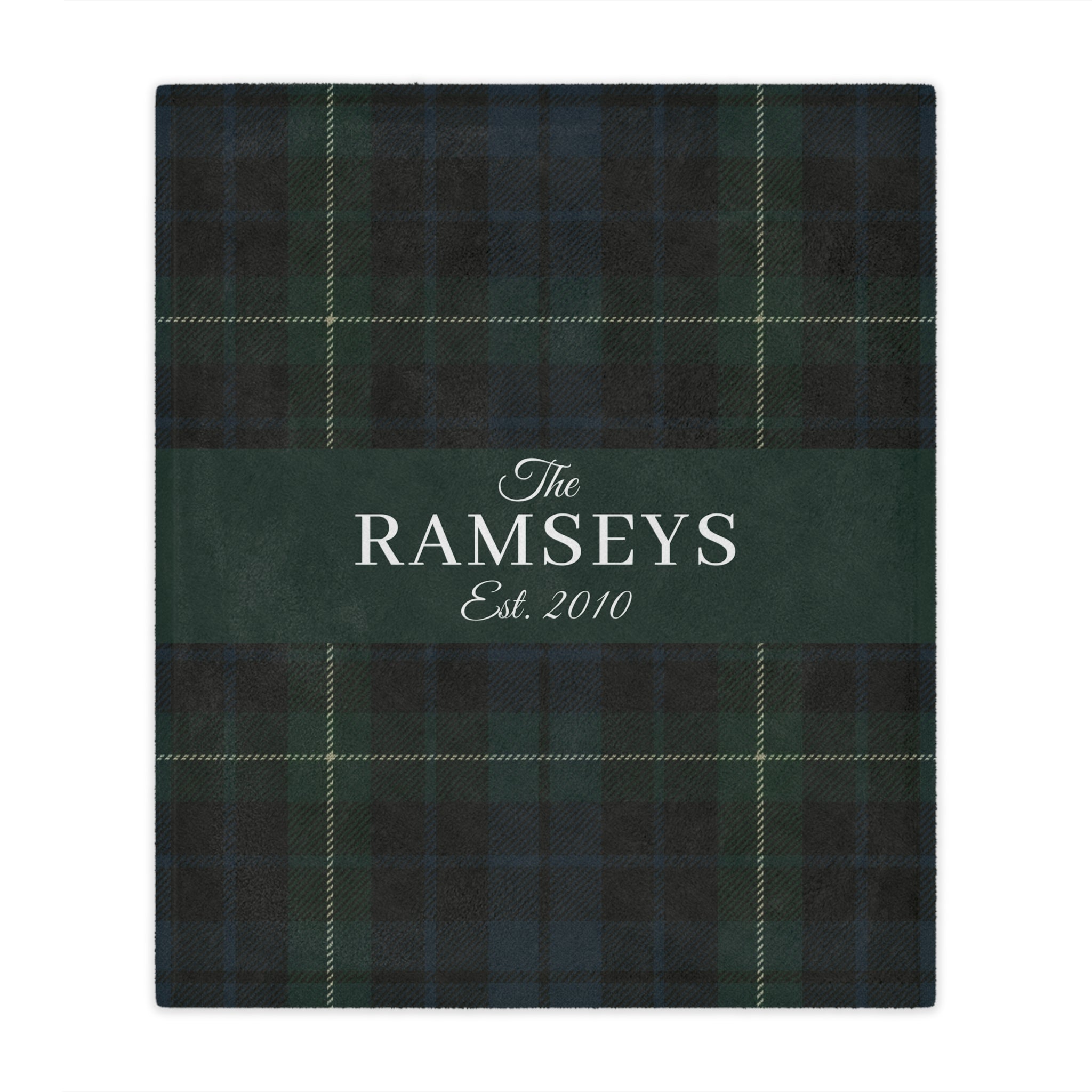 Green plaid blanket with 'The Ramseys Est. 2010' text