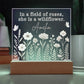 Decorative light with floral design and text on a dark background